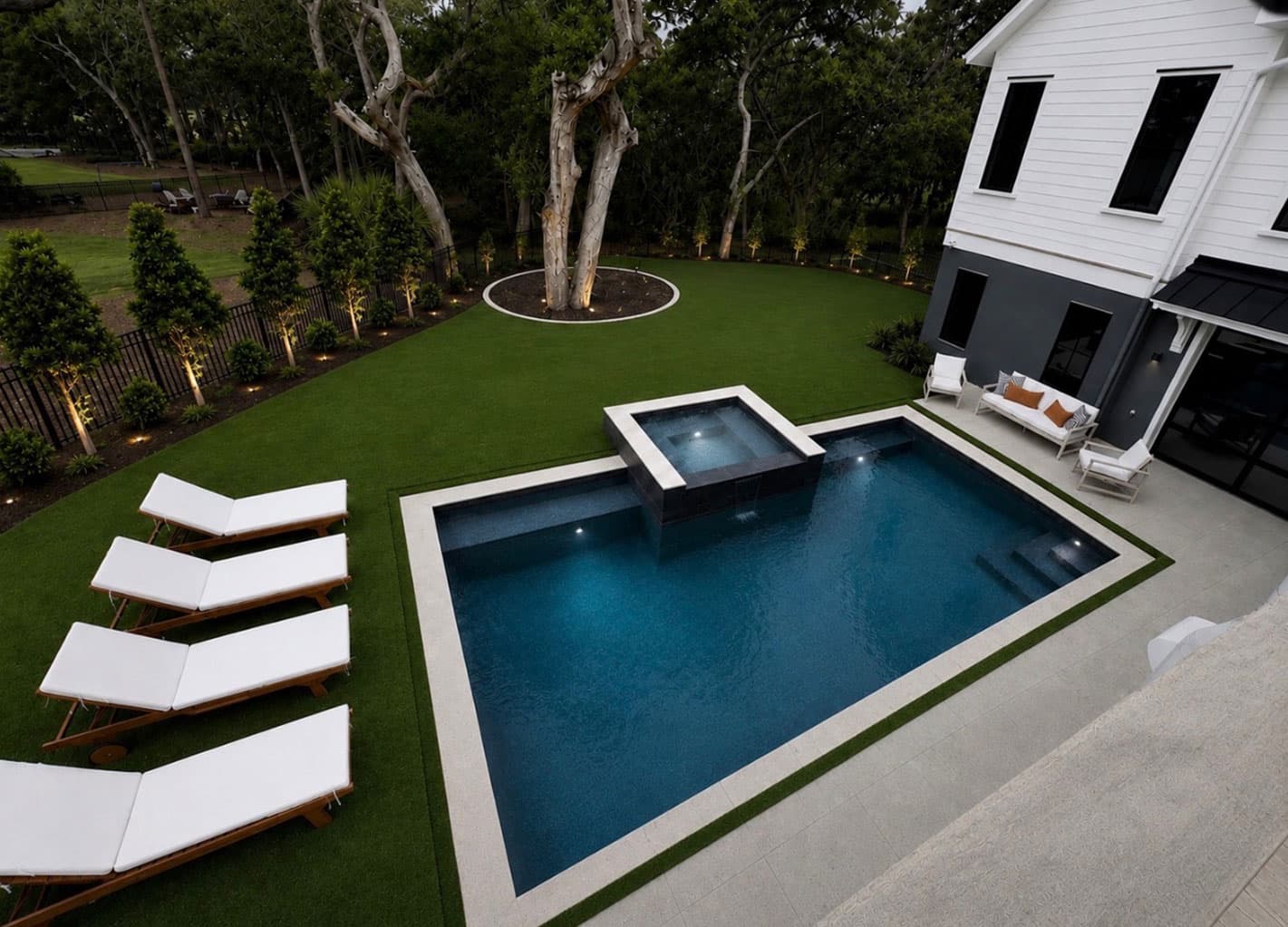 Artificial turf surrounding a swimming pool deck
