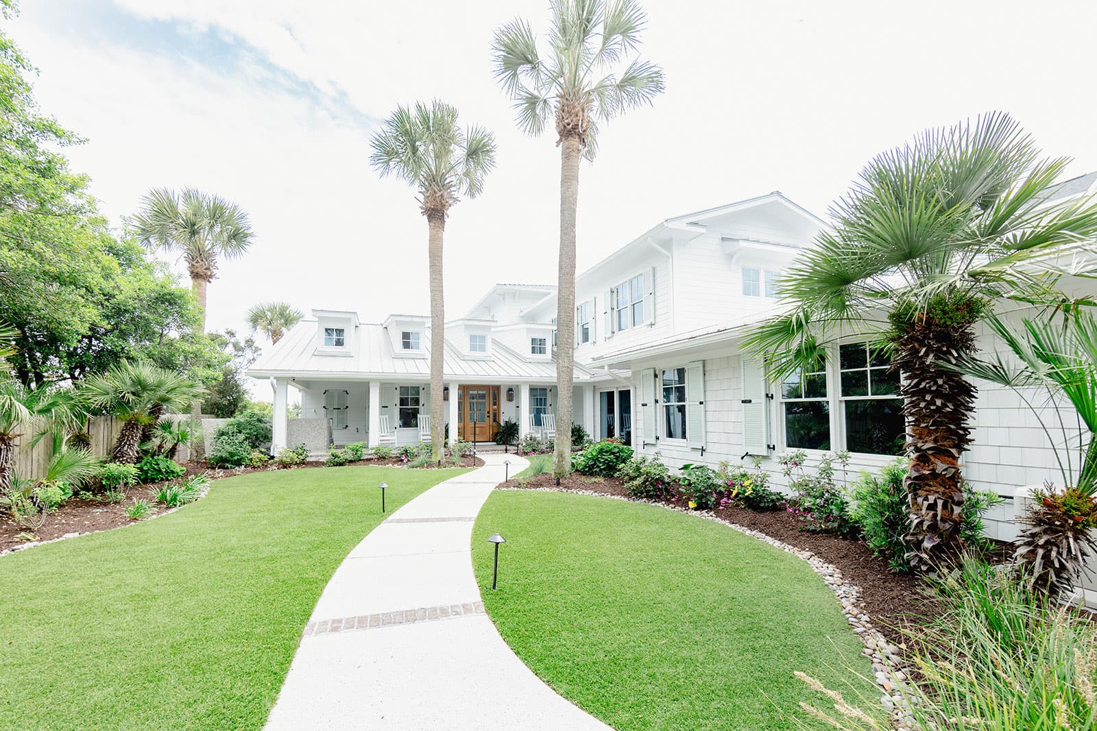 Home with artificial turf lawn and mature landscaping